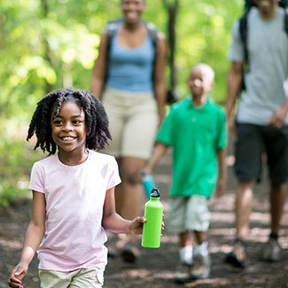 A family walking on a forest path