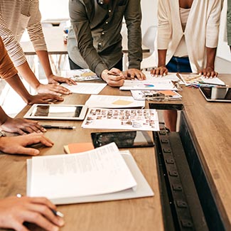 People leaning around a boardroom table