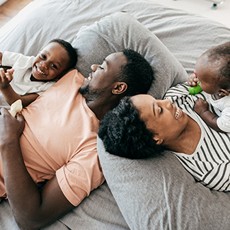 A young family on a bed