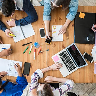 Overhead view of staff working around a table