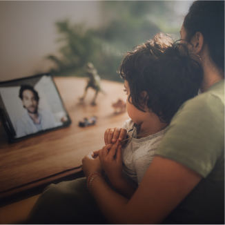 Un parent et un enfant parlent à un médecin sur une tablette