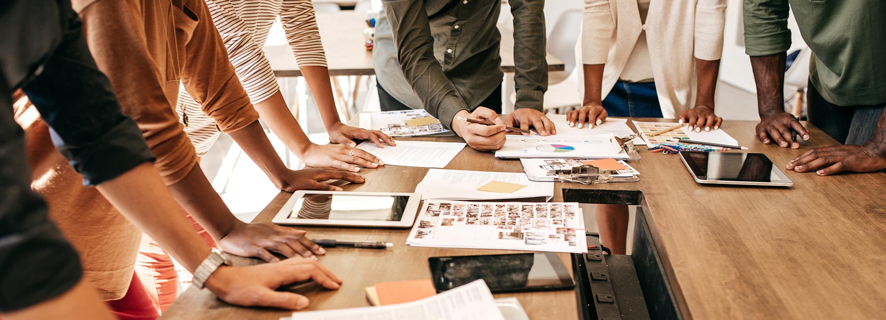 People leaning around a boardroom table