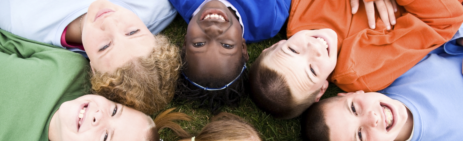 kids laying on ground in circle